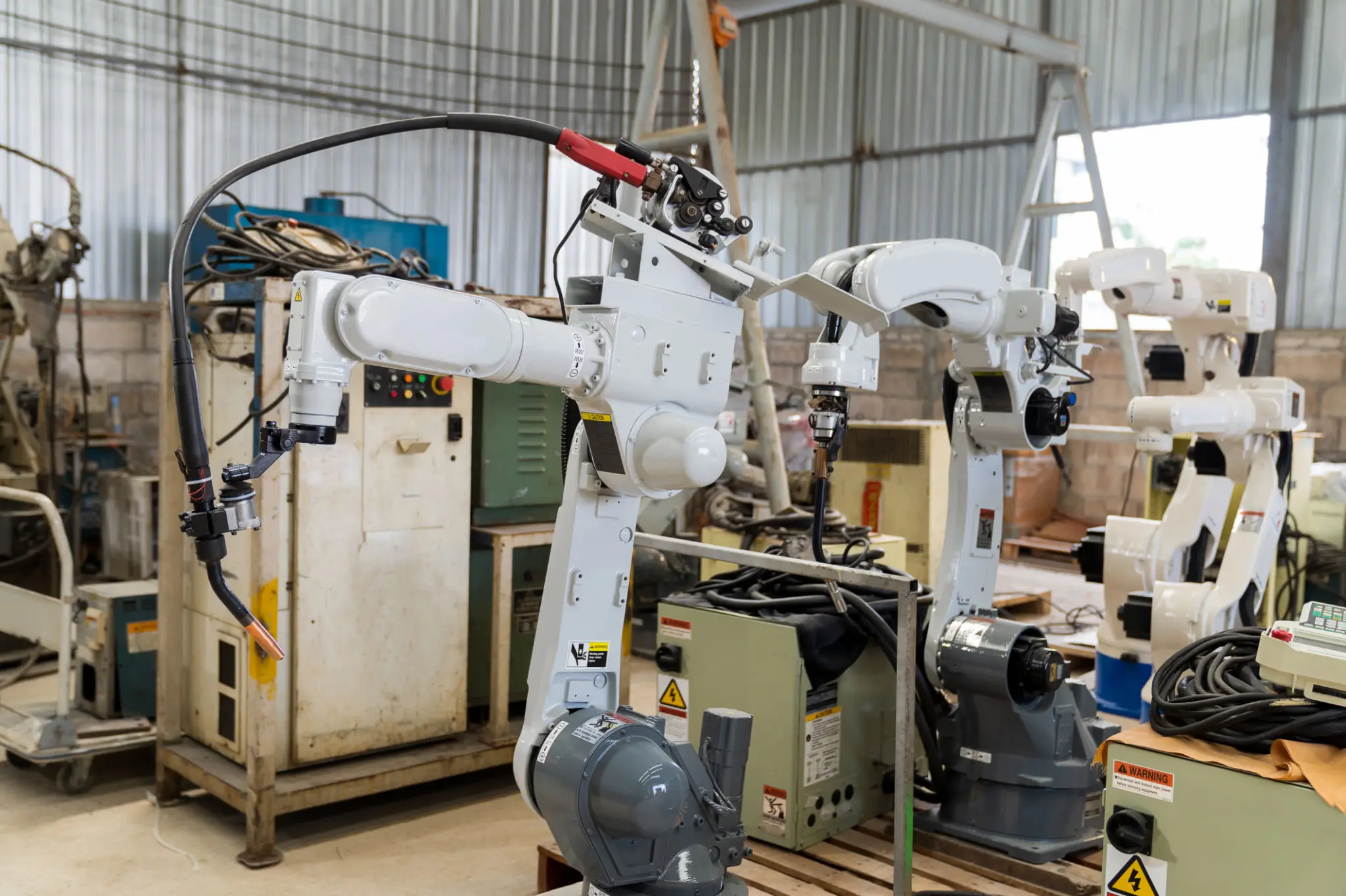 Industrial robotic arms in a workshop
