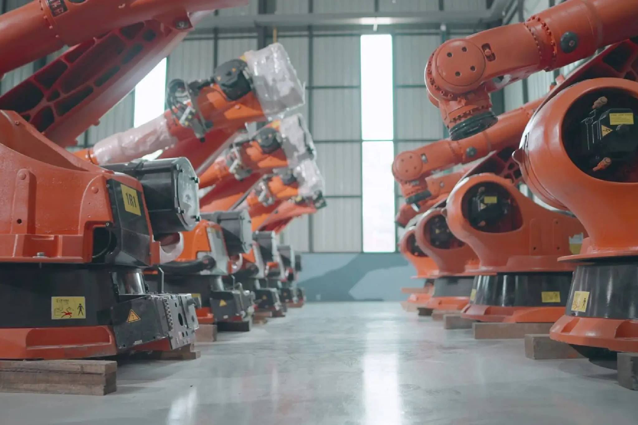 Orange robots lined up in factory