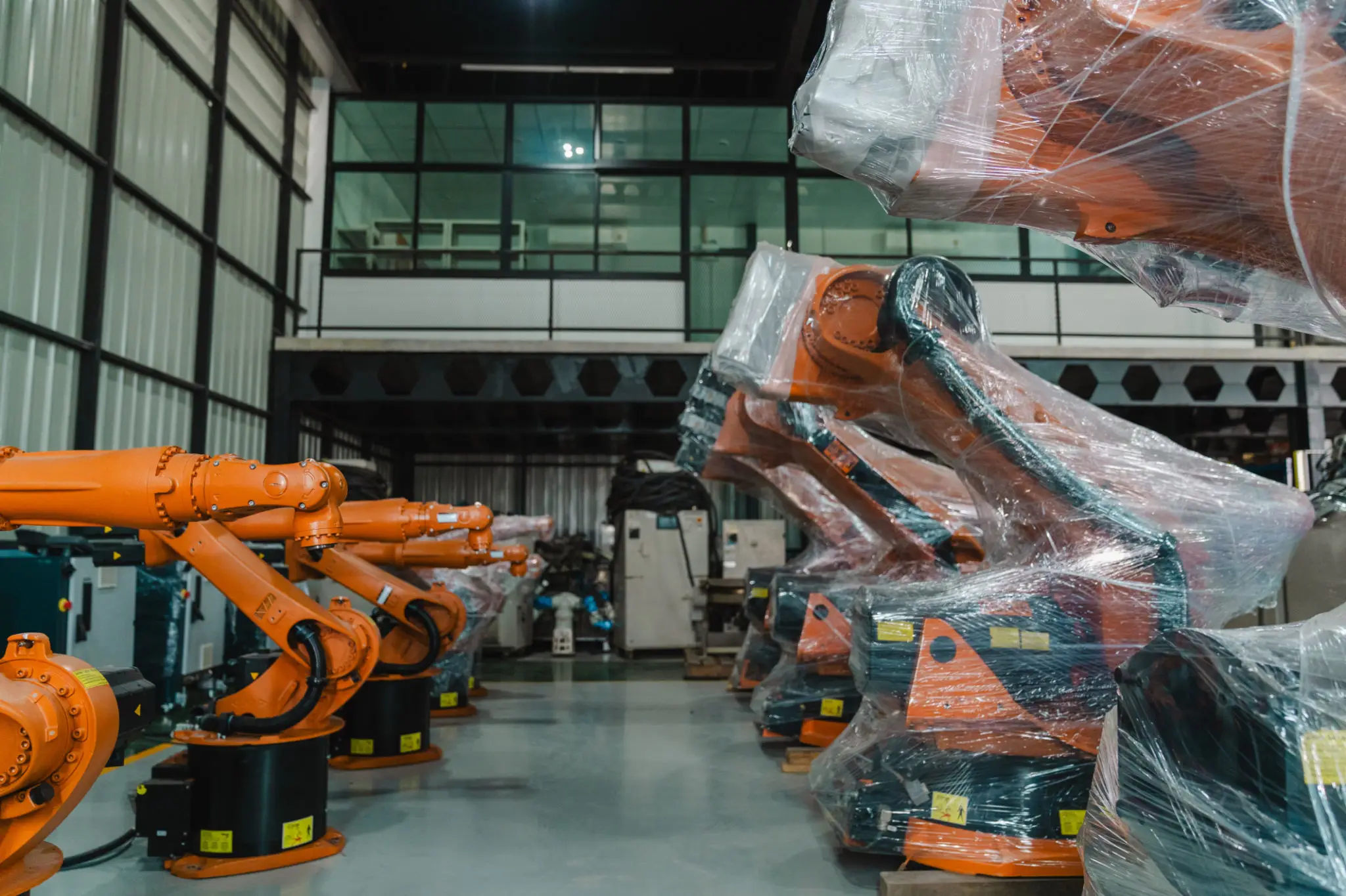 Industrial robots lined up in warehouse