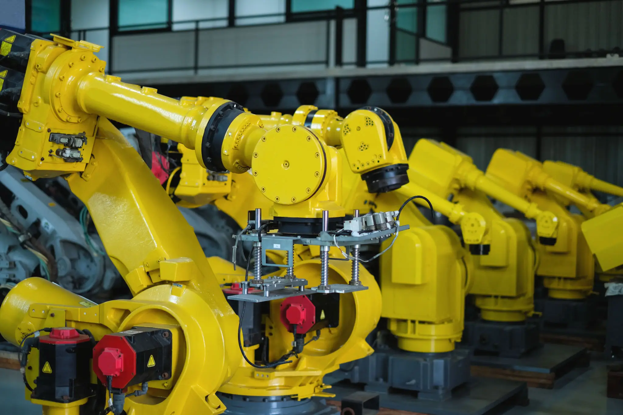 Yellow industrial robots in a factory
