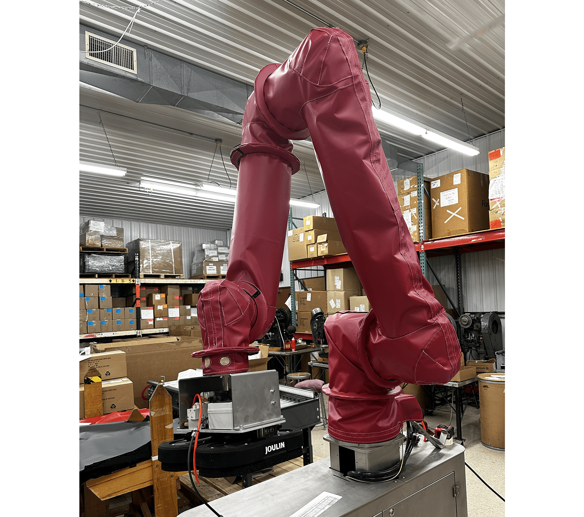 Red robotic arms in a warehouse setting.